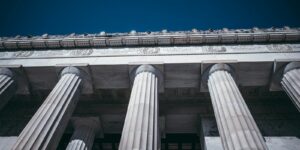 Neoclassical building facade with grand columns and blue sky
